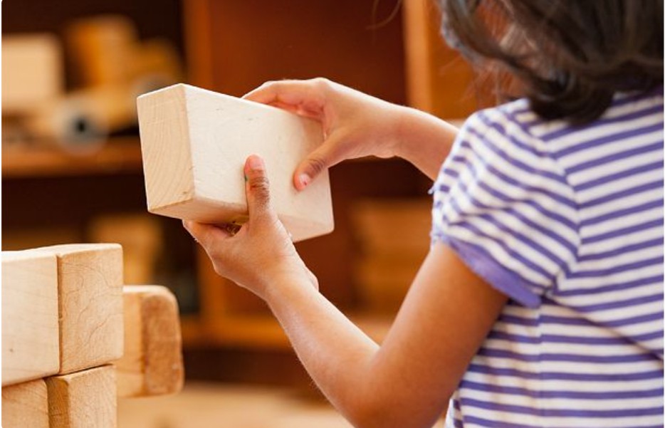 child holding blocks