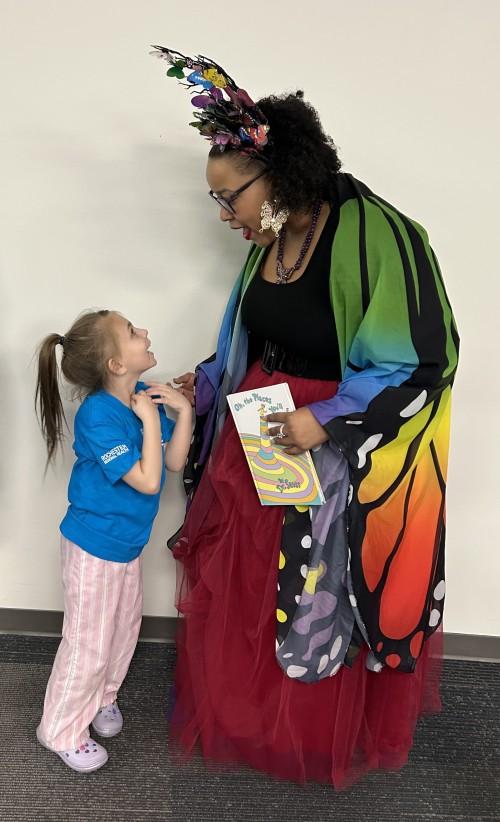 A young child looks up at a storyteller